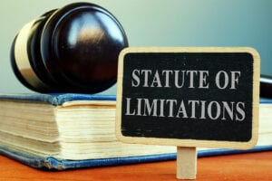 Statute of limitations sign, book and gavel.